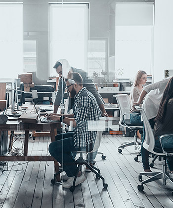 employees working in a glass office