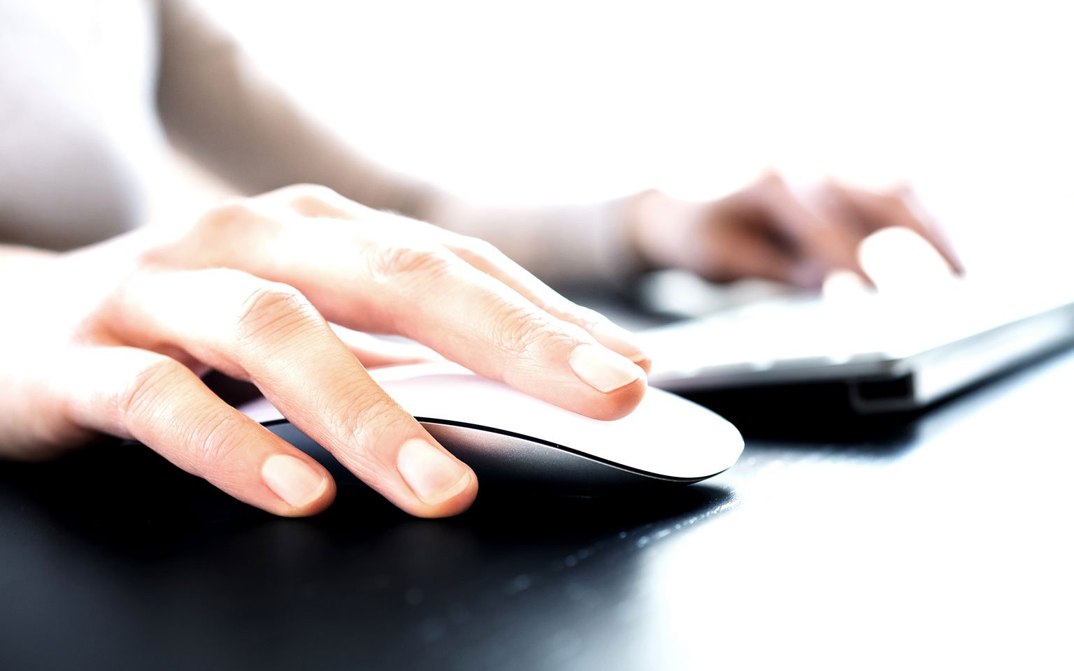 close up of hands typing on a laptop