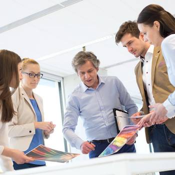 Innovation Toner-Only colleagues discussing coloured printouts